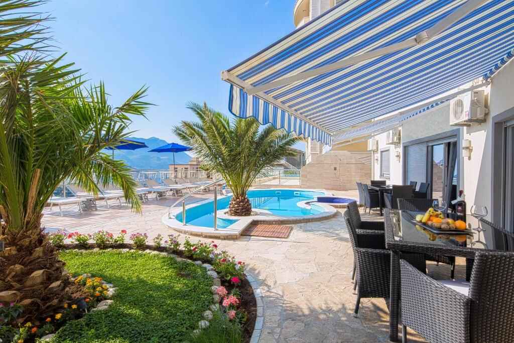 Pool terrace and dining area at Montelux Apartments